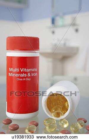 Stock Image - Vitamin pills on bathroom shelf. Fotosearch