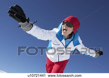 Stock Image - Woman Having Fun On Ski Holiday In Mountains. Fotosearch