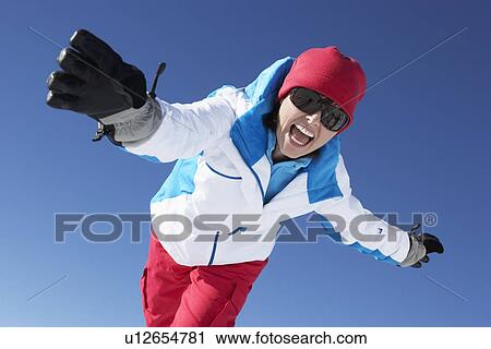 Stock Image - Woman Having Fun On Ski Holiday In Mountains. Fotosearch