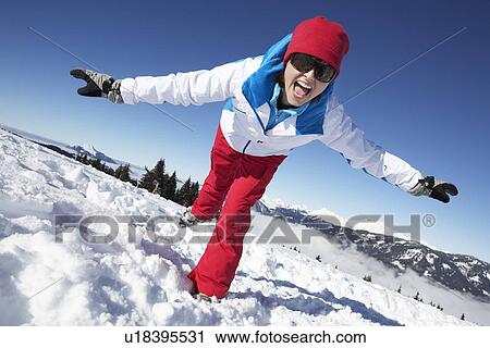 Stock Image - Woman Having Fun On Ski Holiday In Mountains. Fotosearch