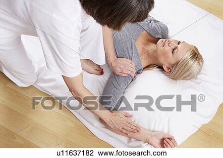 Stock Image - Woman having Shiatsu massage. Fotosearch