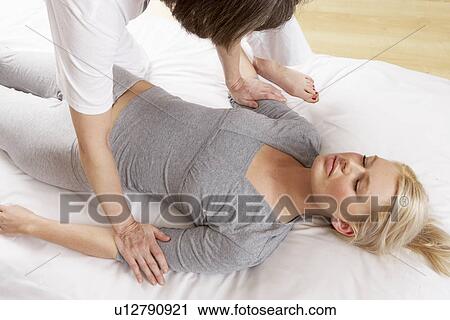 Stock Image - Woman having Shiatsu massage. Fotosearch
