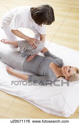Stock Photograph - Woman having Shiatsu massage. Fotosearch