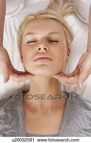 Stock Image - Woman having Shiatsu massage to head. Fotosearch