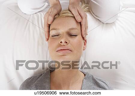 Stock Photograph - Woman having Shiatsu massage to head. Fotosearch