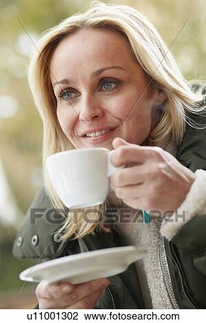 Woman In Outdoor Café With Hot Drink Wearing Winter Clothes View Large Photo Image Stock Image - Woman In Outdoor Café With Hot Drink Wearing Winter Clothes. Fotosearch