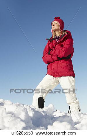 Woman Standing In Snow Wearing Warm Clothes On Ski Holiday In Mountains View Large Photo Image Stock Image - Woman Standing In Snow Wearing Warm Clothes On Ski Holiday In Mountains. Fotosearch