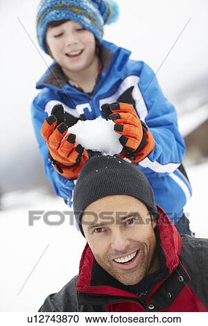 Young Boy About To Drop Snowball On Fathers Head View Large Photo Image Stock Image - Young Boy About To Drop Snowball On Fathers Head. Fotosearch