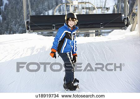 Young Boy Getting Off chair Lift On Ski Holiday In Mountains View Large Photo Image Picture - Young Boy Getting Off chair Lift On Ski Holiday In Mountains. Fotosearch