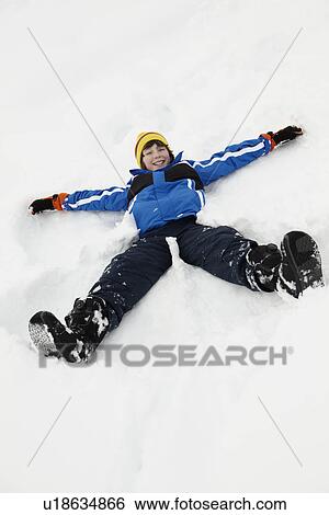 Young Boy Making Snow Angel On Slope View Large Photo Image Stock Photograph - Young Boy Making Snow Angel On Slope. Fotosearch