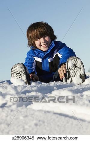 Stock Photography - Young Boy Playing In Snow On Holiday In Mountains. Fotosearch
