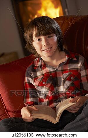 Young Boy Relaxing With Book By Cosy Log Fire View Large Photo Image Stock Image - Young Boy Relaxing With Book By Cosy Log Fire. Fotosearch