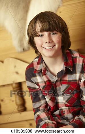 Stock Photo - Young Boy Sitting On Wooden Seat. Fotosearch