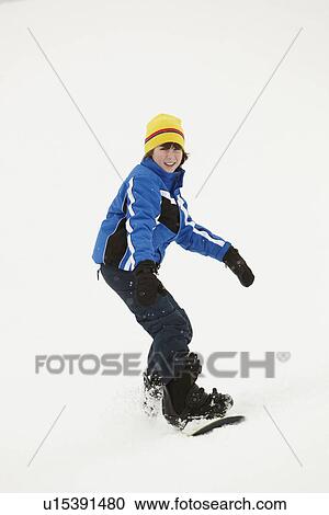 Young Boy Snowboarding Down Slope On Holiday In Mountain View Large Photo Image Stock Image - Young Boy Snowboarding Down Slope On Holiday In Mountain. Fotosearch