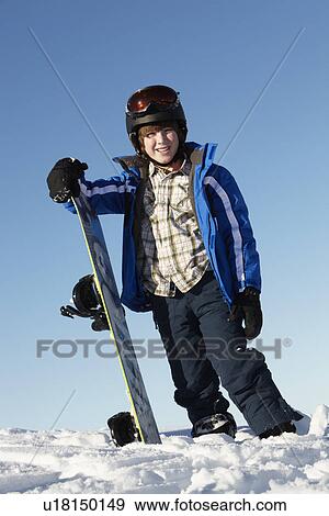 Young Boy With Snowboard On Ski Holiday In Mountains View Large Photo Image Stock Photo - Young Boy With Snowboard On Ski Holiday In Mountains. Fotosearch