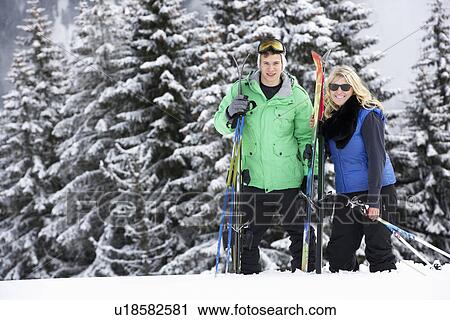 Stock Image - Young Couple On Ski Holiday In Mountains. Fotosearch