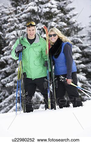 Stock Image - Young Couple On Ski Holiday In Mountains. Fotosearch