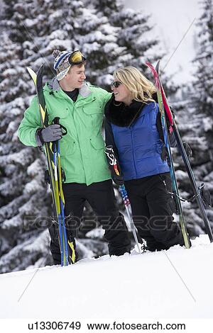 Stock Photo - Young Couple On Ski Holiday In Mountains. Fotosearch