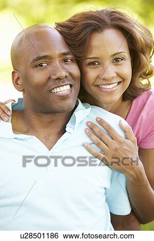 Stock Photograph - Young couple portrait outdoors. Fotosearch