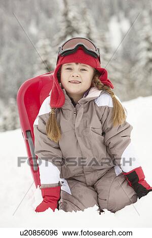 Young Girl Playing In Snow With Sledge On Ski Holiday In Mountains View Large Photo Image Stock Photograph - Young Girl Playing In Snow With Sledge On Ski Holiday In Mountains. Fotosearch