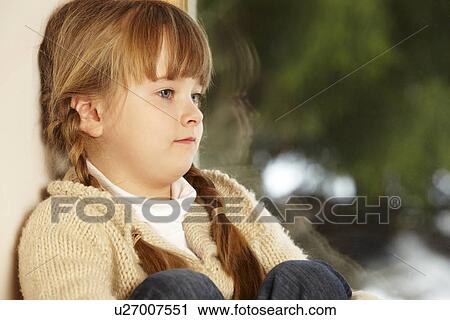 Young Girl Sitting On Window Ledge Looking At Snowy View View Large Photo Image Stock Image - Young Girl Sitting On Window Ledge Looking At Snowy View. Fotosearch