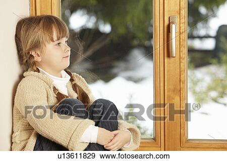 Young Girl Sitting On Window Ledge Looking At Snowy View View Large Photo Image Stock Photo - Young Girl Sitting On Window Ledge Looking At Snowy View. Fotosearch