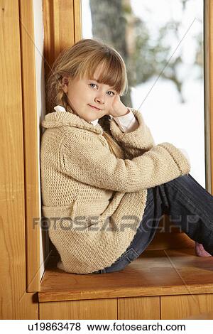Young Girl Sitting On Window Ledge Looking At Snowy View View Large Photo Image Stock Photo - Young Girl Sitting On Window Ledge Looking At Snowy View. Fotosearch