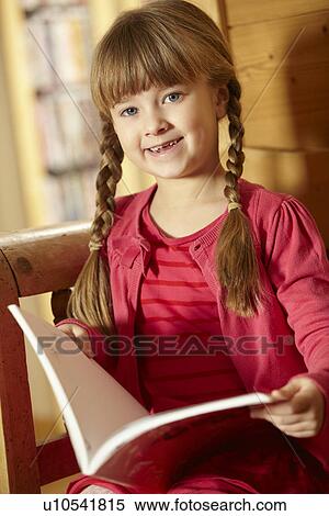Stock Photography - Young Girl Sitting On Wooden Seat Reading Book. Fotosearch