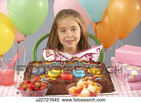 Young girl with birthday cake and gifts at party View Large Photo Image Stock Photography - Young girl with birthday cake and gifts at party. Fotosearch