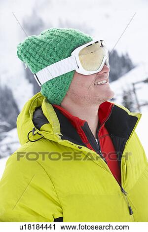Stock Image - Young Man On Ski Holiday In Mountains. Fotosearch
