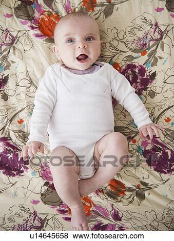 Baby boy (2-5 months) lying on bed View Large Photo Image Stock Photo - Baby boy (2-5 months) lying on bed. Fotosearch
