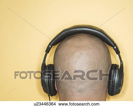 Back view of man with headphones on head View Large Photo Image Picture - Back view of man with headphones on head. Fotosearch