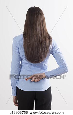 Stock Photograph - Back view of woman with crossed fingers. Fotosearch