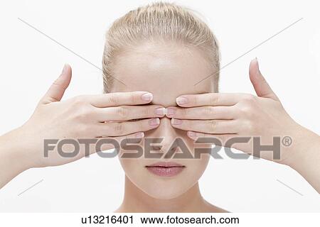 Stock Image - Beauty portrait of woman covering eyes. Fotosearch
