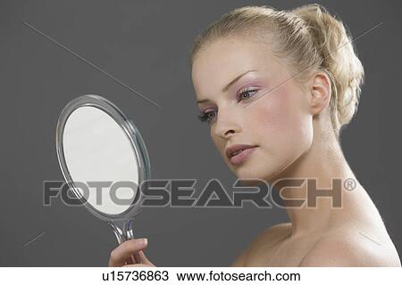 Beauty portrait of woman looking in mirror View Large Photo Image Stock Image - Beauty portrait of woman looking in mirror. Fotosearch