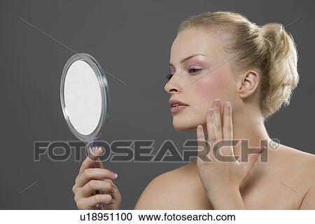 Beauty portrait of woman looking in mirror View Large Photo Image Stock Image - Beauty portrait of woman looking in mirror. Fotosearch