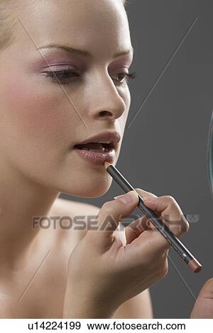 Beauty portrait of woman using lip liner View Large Photo Image Stock Photo - Beauty portrait of woman using lip liner. Fotosearch
