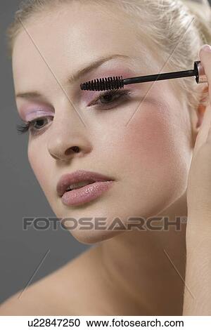 Beauty portrait of woman using mascara View Large Photo Image Stock Image - Beauty portrait of woman using mascara. Fotosearch