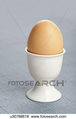 Stock Photo - Boiled egg in cup. Fotosearch