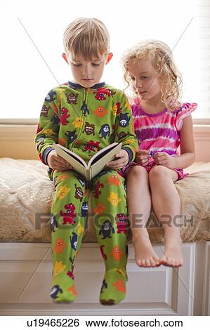 Brother (6-7) and sister (4-5) reading book together View Large Photo Image Stock Photograph - Brother (6-7) and sister (4-5) reading book together. Fotosearch