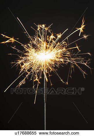 Stock Photography - Burning sparkler on black background. Fotosearch