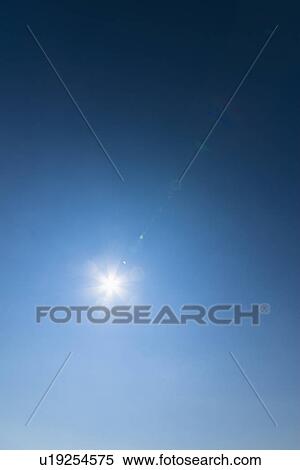 Stock Photography - Clear blue sky and solar flare. Fotosearch