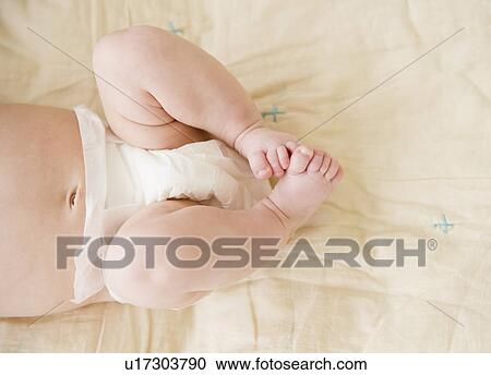 Stock Image - Close-up view of baby boy's feet (2-5 months). Fotosearch