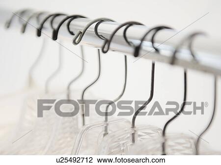 Coat hangers on clothes rack View Large Photo Image Stock Image - Coat hangers on clothes rack. Fotosearch