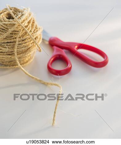 Picture - Coiled string and scissors. Fotosearch