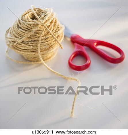 Stock Image - Coiled string and scissors. Fotosearch