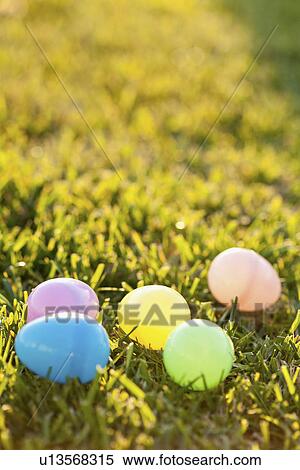Stock Photography - Colorful eggs laying on grass. Fotosearch