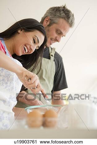 Couple cooking together View Large Photo Image Stock Image - Couple cooking together. Fotosearch
