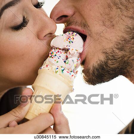 Couple eating ice cream together View Large Photo Image Stock Photography - Couple eating ice cream together. Fotosearch