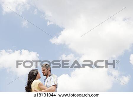 Couple embracing outdoors View Large Photo Image Picture - Couple embracing outdoors. Fotosearch